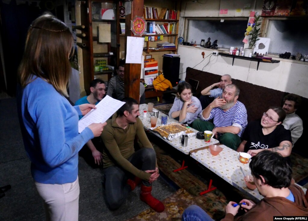 Mikheil Sannikov (center-right) is read a poem at his birthday party in November 2016. The 59-year-old is known as Lama Dokshit to his followers.