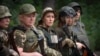 Volunteers of the women's mobile air-defense group Bucha Witches train in the Bucha district outside Kyiv on August 3 to shoot down Russian drones approaching the capital.