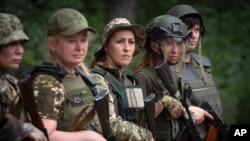 Volunteers of the women's mobile air-defense group Bucha Witches train in the Bucha district outside Kyiv, where they attempt to shoot down Russian drones approaching the capital.