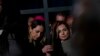Two nurses, Albina (right) from Russia and Iryna from Ukraine, hold a cross as they take part in a torchlight procession presided over by Pope Francis in Rome on Good Friday. 