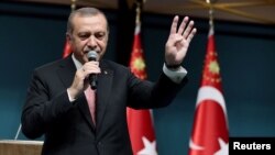 Turkish President Tayyip Erdogan addresses the nation in a live television broadcast from the presidential palace in Ankara on July 21.