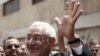 Presidential candidate Abdel Moneim Abul Fotouh waves after casting his vote at a polling station in Cairo. A Fotouh presidency could present a challenge to the ruling military council.