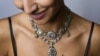 A model poses with a parure of antique colored diamond jewels during a press preview by Sotheby's auction house in Geneva, November 9, 2016