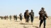 FILE: Afghan forces patrol in the southern province of Helmand in November.