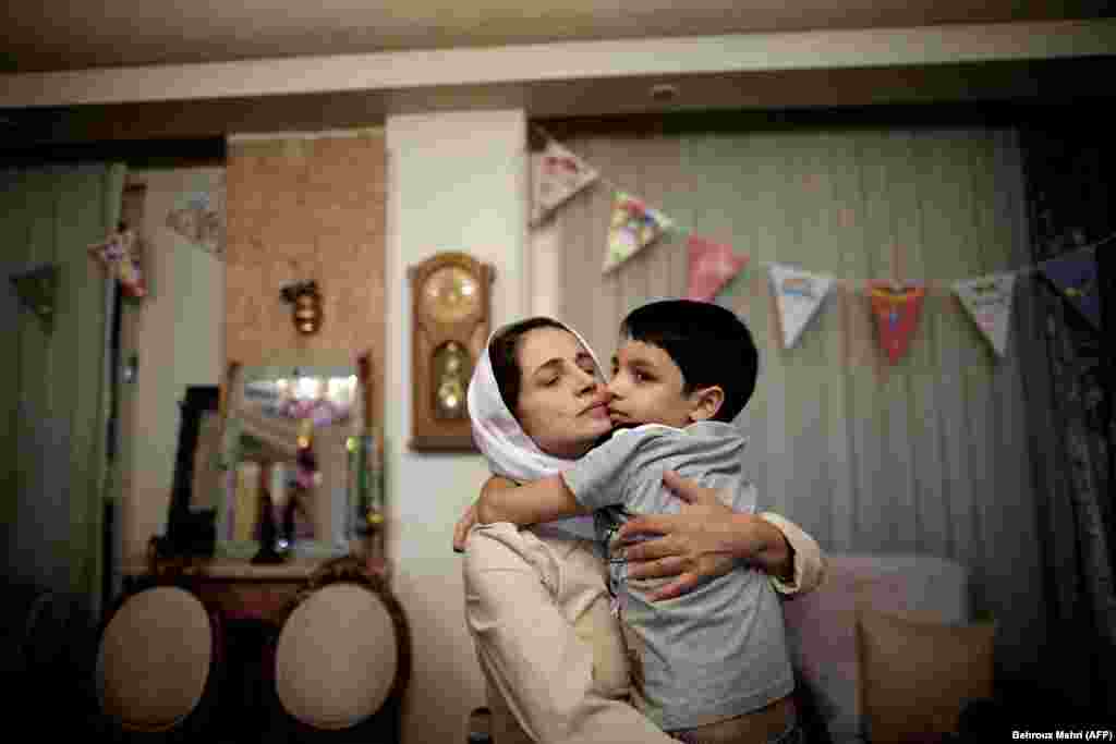 Iranian lawyer Nasrin Sotoudeh hugs her son Nima at her home in Tehran. (AFP/Behrouz Mehri)