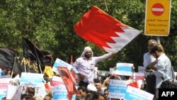 Demonstrators wave Bahraini flags during a protest after Friday prayers on May 18 in Tehran against alleged plans for a union between Saudi Arabia and Bahrain 