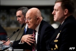 U.S. Defense Undersecretary for Intelligence Marcell Lettre (left), Director of National Intelligence James Clapper (center), and National Security Agency Director Admiral Michael Rogers testify before the Senate Armed Services Committee in Washington on January 5.