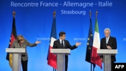 German Chancellor Angela Merkel (left), French President Nicolas Sarkozy (center) and Italian Prime minister Mario Monti attend a press conference during a European mini-summit on the debt crisis in Strasbourg, France.