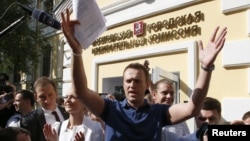 Aleksei Navalny speaks outside the Moscow Election Commission shortly before being briefly detained by police.