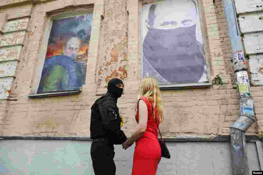 A fighter of Social Nationalist Assembly, part of ultranationalist Right Sector party, says farewell to his girlfriend before heading to eastern Ukraine as part of the "Azov" battalion during a ceremony in their headquarters in Kyiv, on June 3. (Reuters/Valentyn Ogirenko)