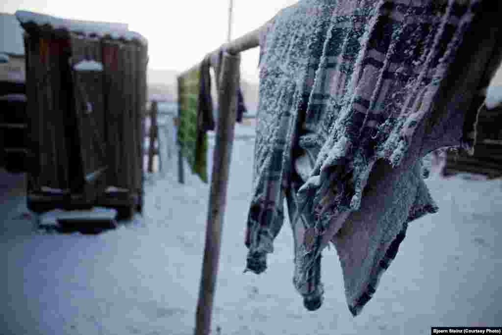 Frozen clothes hang on the line in Oymyakon.