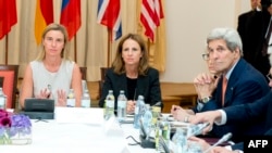 European Union foreign policy chief Federica Mogherini (left) and U.S. Secretary of State John Kerry (right) meet on July 7 at the Palais Coburg Hotel in Vienna, where the Iran nuclear talks meetings are being held.