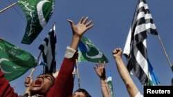 Supporters of Islamic parties hold party flags and shout slogans as they demand punishment for Asia Bibi, a Christian woman sentenced to death for blasphemy, during a rally in Karachi on December 3.