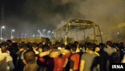 At least 11 people, and possibly many more, were killed in a crash of a tanker and passenger bus in Iran.