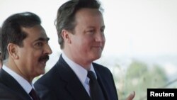 Pakistani Prime Minister Yusuf Raza Gilani (left) welcomes his British counterpart, David Cameron, to Islamabad today.