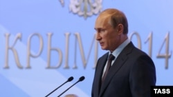 Russian President Vladimir Putin addresses members of the Russian State Duma's factions and ministers in Yalta, Crimea, on August 14.