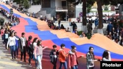 Nagorno-Karabakh - Schoolchidren carry a huge Karabakh Armenian flag during a public celebration in Stepanakert, 9May2016.