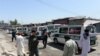 Ambulances transport the bodies of Afghan Sikhs killed in a suicide attack in Jalalabad on July 2.