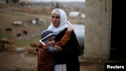 Iraq -- Ayman, a boy from a minority Yazidi community, who was sold by Islamic State militants to a Muslim couple in Mosul, hugs his grandmother after he was returned to his Yazidi family, in Duhok, Iraq, January 31, 2017