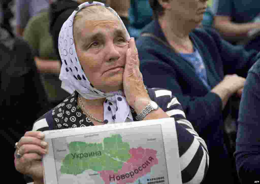 A woman holds a map depicting Novorossia, a historical term referring to the area north of the Black Sea now a part of Ukraine, and cries during a rally in support of the self-proclaimed &quot;Donetsk People&#39;s Republic&quot; in Donetsk. (AFP/Daniel Mihailescu)