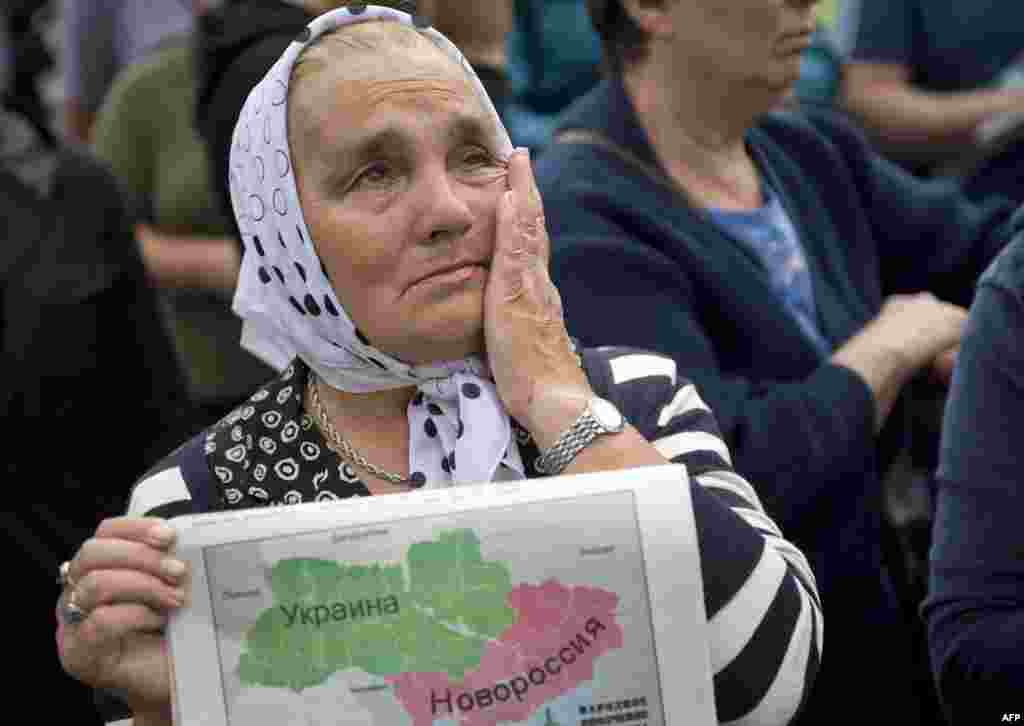 A woman holds a map depicting Novorossia, a historical term referring to the area north of the Black Sea now a part of Ukraine, and cries during a rally in support of the self-proclaimed "Donetsk People's Republic" in Donetsk. (AFP/Daniel Mihailescu)