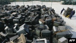 Workers at China's biggest used home-appliance recycling factory in Jingmen, central China.