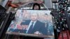 An activist from a pro-Kremlin movement holds a placard with a portrait of Russian President Vladimir Putin in front of the State Duma in Moscow on January 23.