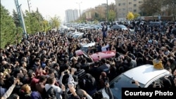 Mourners pay their respects to Morteza Pashaei outside the Tehran hospital where he died on November 14. The last time Iranians took to the streets spontaneously in such large numbers was following the disputed 2009 presidential election.