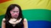 A doll with Vladimir Putin's face next to a gay rights flag as protesters demonstrate outside Downing Street in central London, in August, 2013.