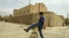 An Iraqi boy plays in front of a closed synagogue in Baghdad. Only a few Jews remain in Iraq today.