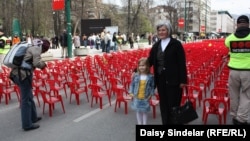 Biba Mehimovic stands with her granddaughter Sara in front of the small red chairs symbolizing the 643 children who died in the siege.