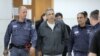Former Israeli cabinet minister Gonen Segev (center) arrives at court in Jerusalem on February 26. 