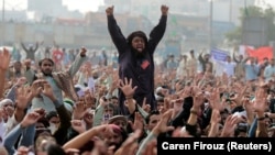 Members of the Tehreek-e-Labaik Pakistan far right Islamist political party shout slogans during a sit-in in Rawalpindi and Islamabad on November 10.