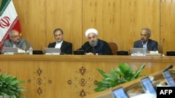 Iranian President Hassan Rohani (2nd R) sits next to Vice President Eshaq Jahangiri (2nd L) during a cabinet meeting in Tehran, July 19, 2017