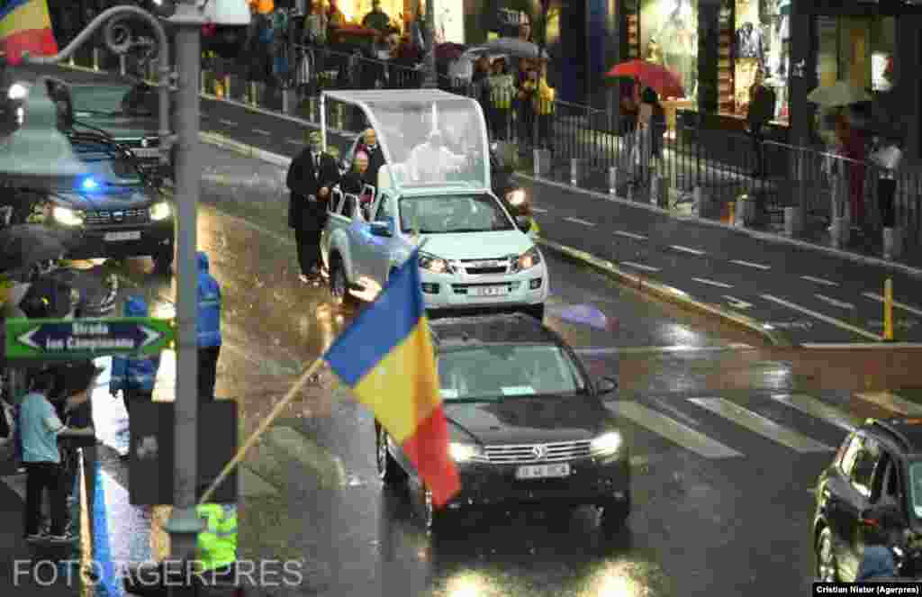 În ciuda ploii torențiale, Papa, în vârstă de 83 de ani, a decis să meargă cu Papamobilul. Pe Calea Victoriei, mii de oameni l-au așteptat în ploaie, fluturând stegulețe, filmând sau făcând fotografii. Puțini aveau umbrele, de teamă probabil că nu l-ar mai putea vedea pe Papă.