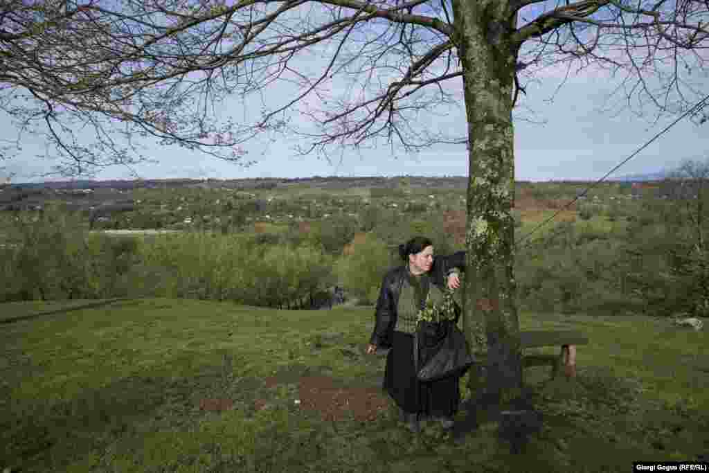 The pilgrimage involves a steep 3-kilometer hike to the site of the Church of the Archangel. While some people choose to navigate the bumpy path in SUVs, most people make the strenuous hike on foot, with some even choosing to go barefoot. Here, a participant stops for a rest.&nbsp;