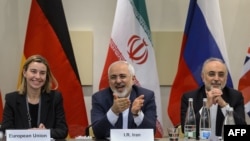 Switzerland -- (L-R) EU foreign policy chief Federica Mogherini, Iranian Foreign Minister Mohammad Javad Zarif and Head of Iran Atomic Energy Organization Ali Akbar Salehi wait for the opening of a plenary session on Iran nuclear talks in 2015.