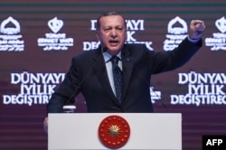 Turkish President Recep Tayyip Erdogan gestures as he addresses supporters in Istanbul on March 12.