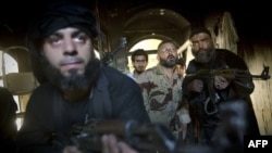 Antigovernment rebels take position in a house during clashes with regime forces in the old city of Aleppo on May 22.