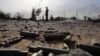 Spent bullet shells litter the ground as a member of the Islamist-linked militia of Misurata walks past following three days of battles in the area of Tripoli's international airport on August 21. 