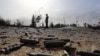 Spent bullet shells litter the ground as a member of the Islamist-linked militia of Misurata walks past following three days of battles in the area of Tripoli&#39;s international airport on August 21. (AFP/Mahmud Turkia)