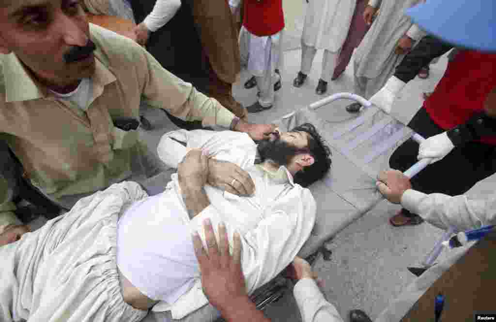 Rescue workers move an injured man at the Lady Reading Hospital in Peshawar, Pakistan.