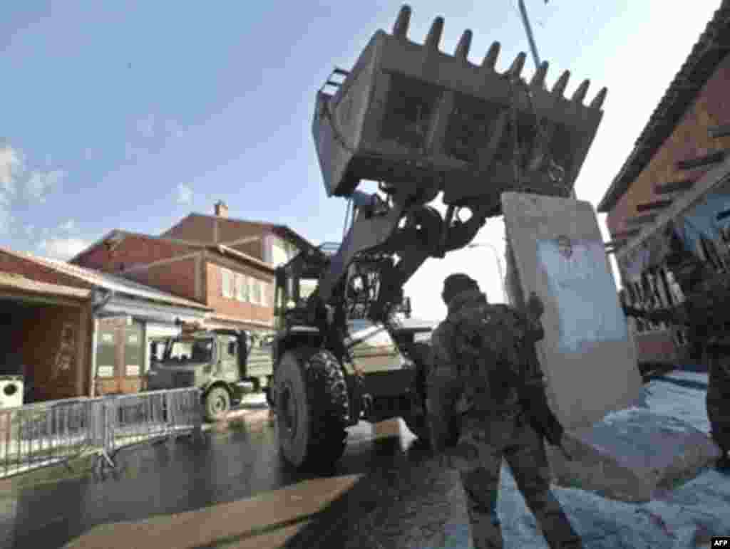 But there have also been security fears. In the ethnically divided city of Mitrovica, French soldiers reinforce their checkpoint with concrete blocks. Kosovo's security remains dependent on the 16,000 NATO troops stationed there, known as KFOR. 