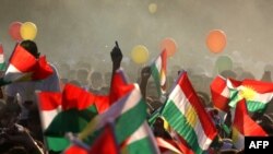 Iraqi Kurds fly Kurdish flags during an event to urge people to vote in the upcoming independence referendum in Arbil, the capital of the autonomous Kurdish region of northern Iraq, on September 15, 2017.