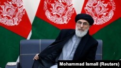 Former Afghan warlord Gulbuddin Hekmatyar arrives to register as a candidate for the presidential election at Afghanistan's Independent Election Commission in Kabul on January 19.