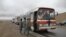 Afghan policemen check buses near Ghazni on March 24.