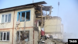 Rescue workers at the blast site in the village of Vozdvizhenka