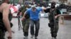 Members of the Vostok Battalion, a pro-Russia militia, escort an activist of the so-called People's Republic of Donetsk after detaining several of them following their storming of the regional state building in the eastern city of Donetsk on May 29.