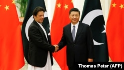 Chinese President Xi Jinping (right) shakes hands with Pakistani Prime Minister Imran Khan in Beijing on November 2.