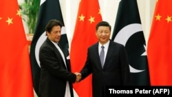 FILE: Chinese President Xi Jinping meets with Pakistani Prime Minister Imran Khan at the Great Hall of the People in Beijing in November 2018.